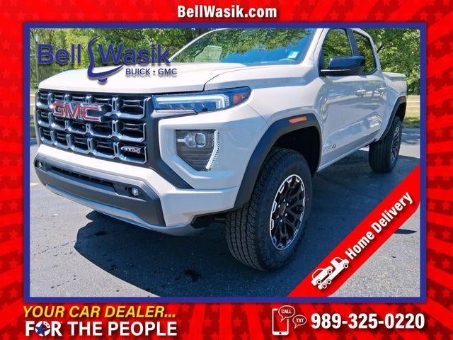 2026 GMC Canyon AT4 in Coastal Dune — front three-quarter view